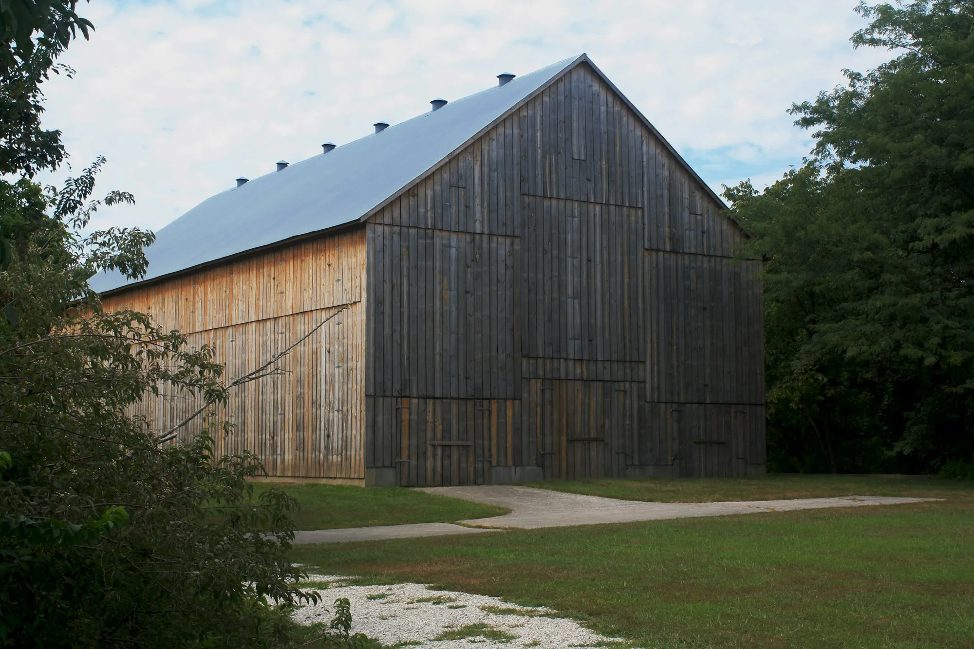 Wood barn with a tall standing seam metal roof